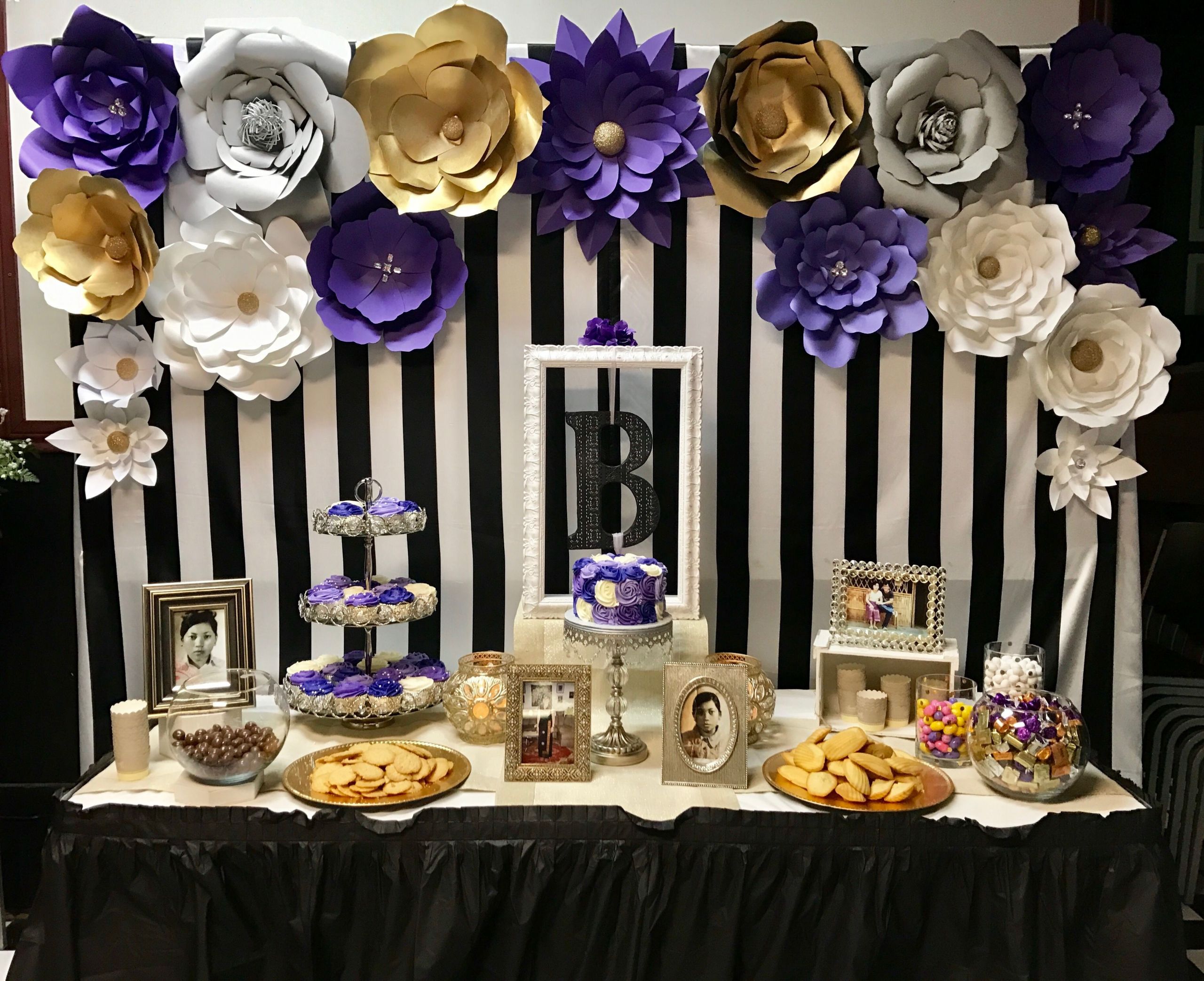 60th Birthday Decorations
 Dessert table with paper flowers backdrop for purple