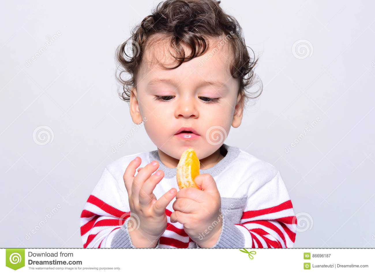 Baby Eating Hair
 Portrait A Cute Baby Eating Orange Stock Image Image