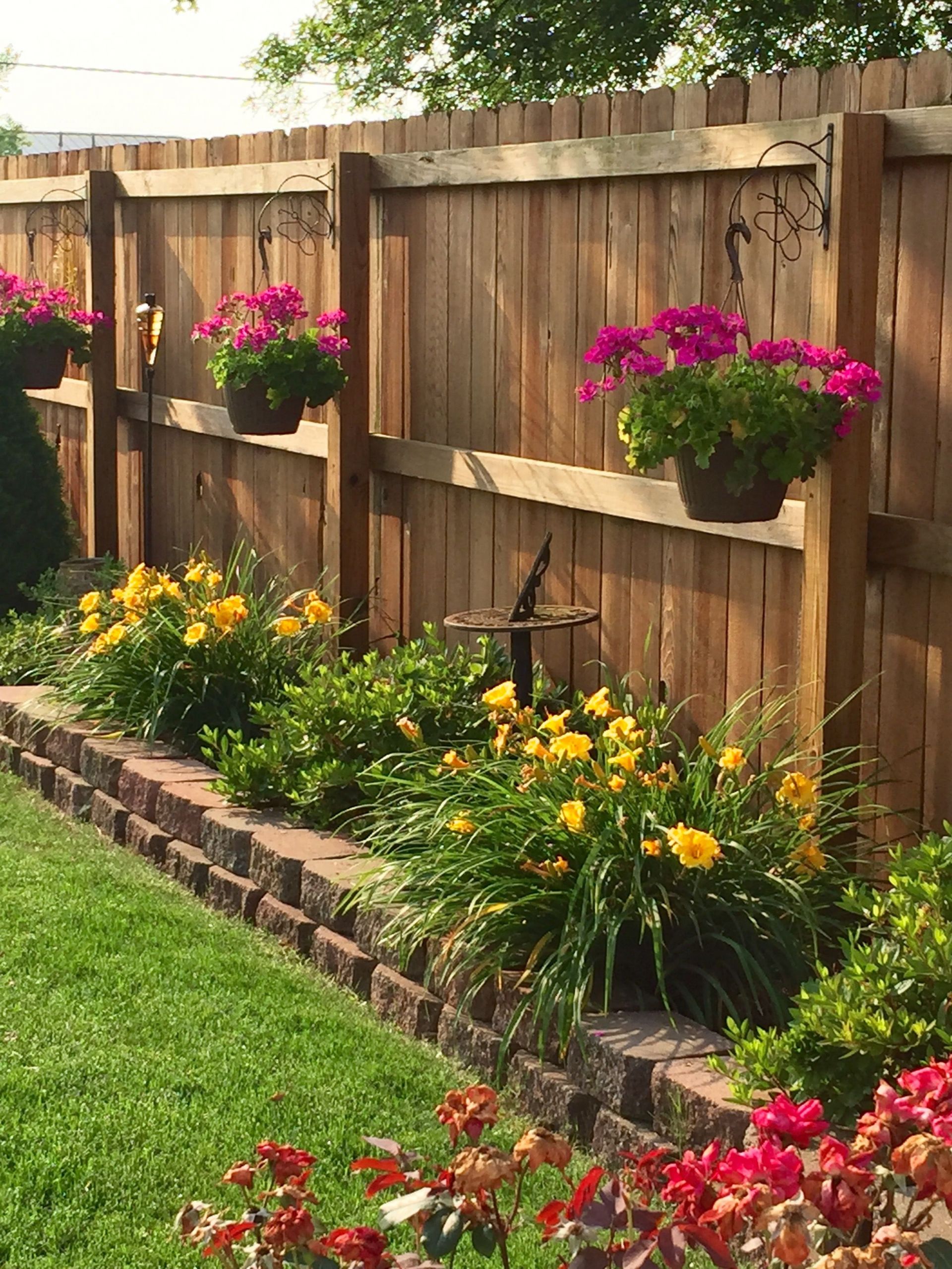 Backyard Wall Ideas
 Bring the flowers high with hanging baskets