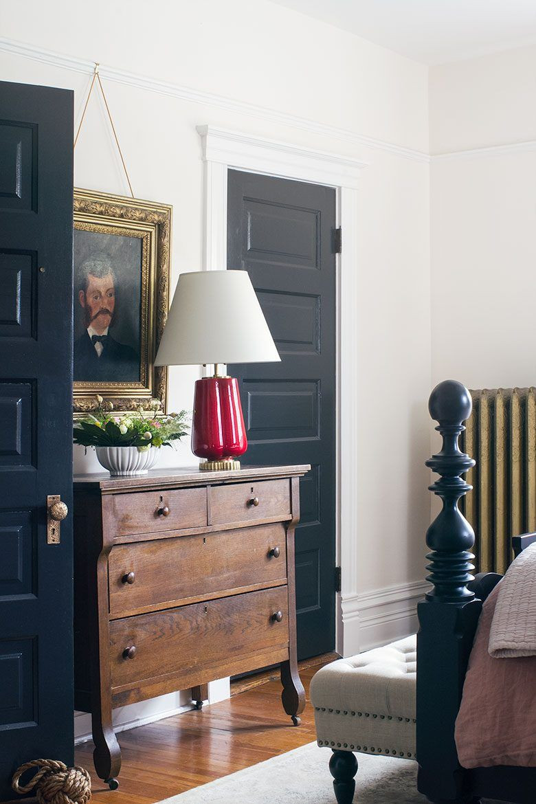 Black Painted Bedroom
 Vintage Wooden Dresser Between Black Painted Doors in the