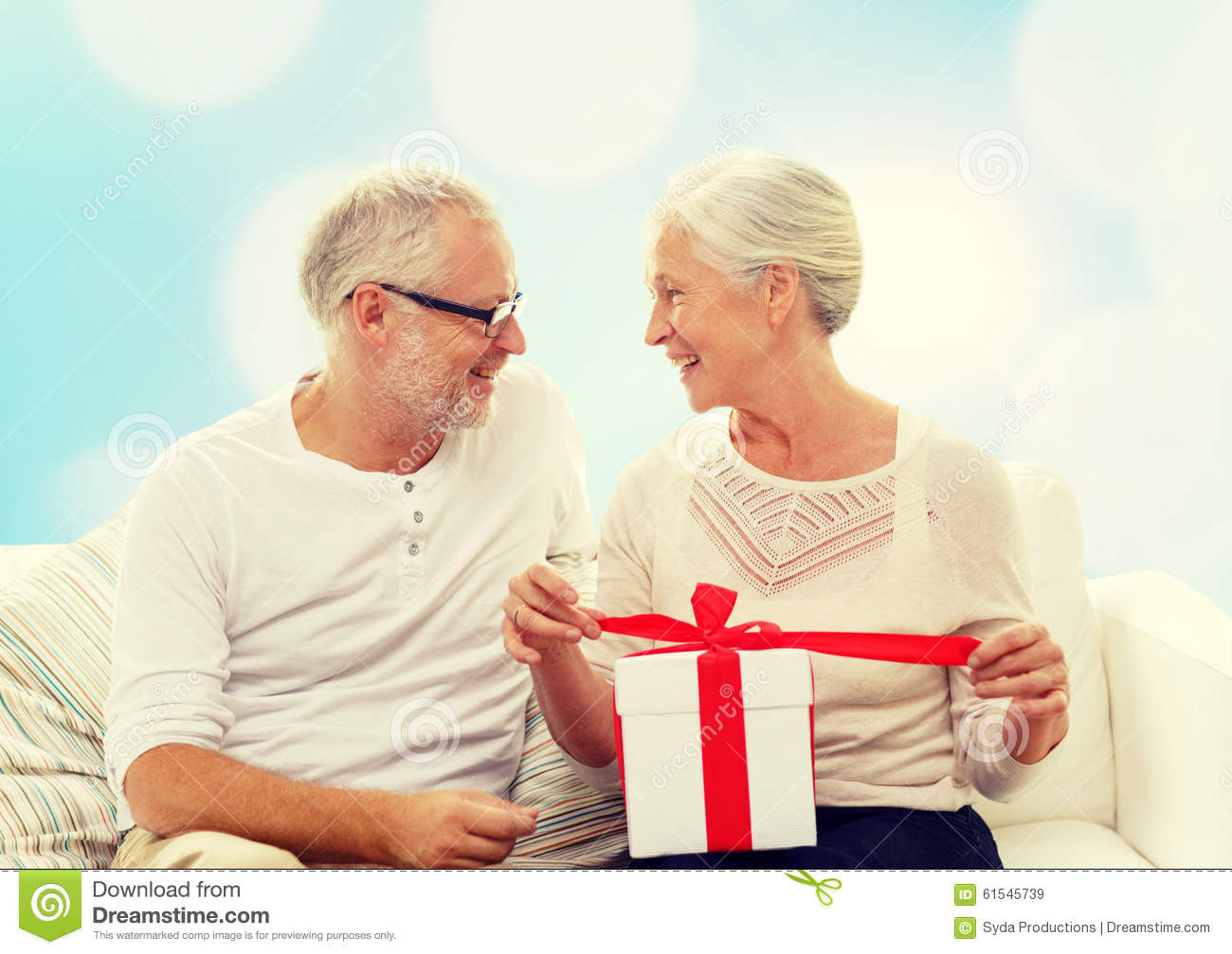 Christmas Gift Ideas For Older Couple
 Happy Senior Couple With Gift Box At Home Stock