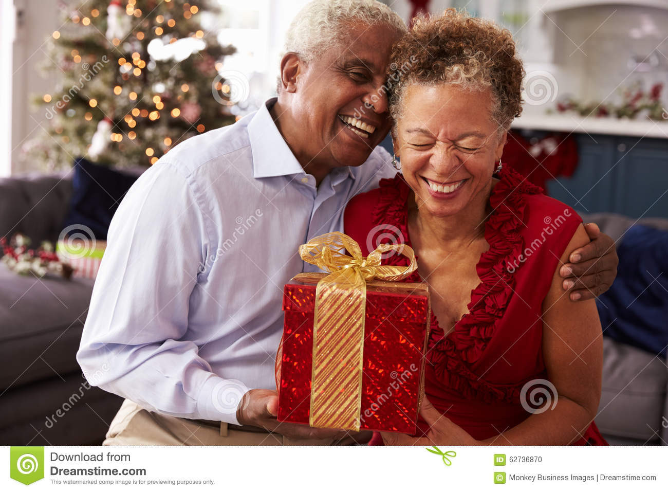 Christmas Gift Ideas For Older Couple
 Senior Couple Exchanging Christmas Gifts At Home Stock