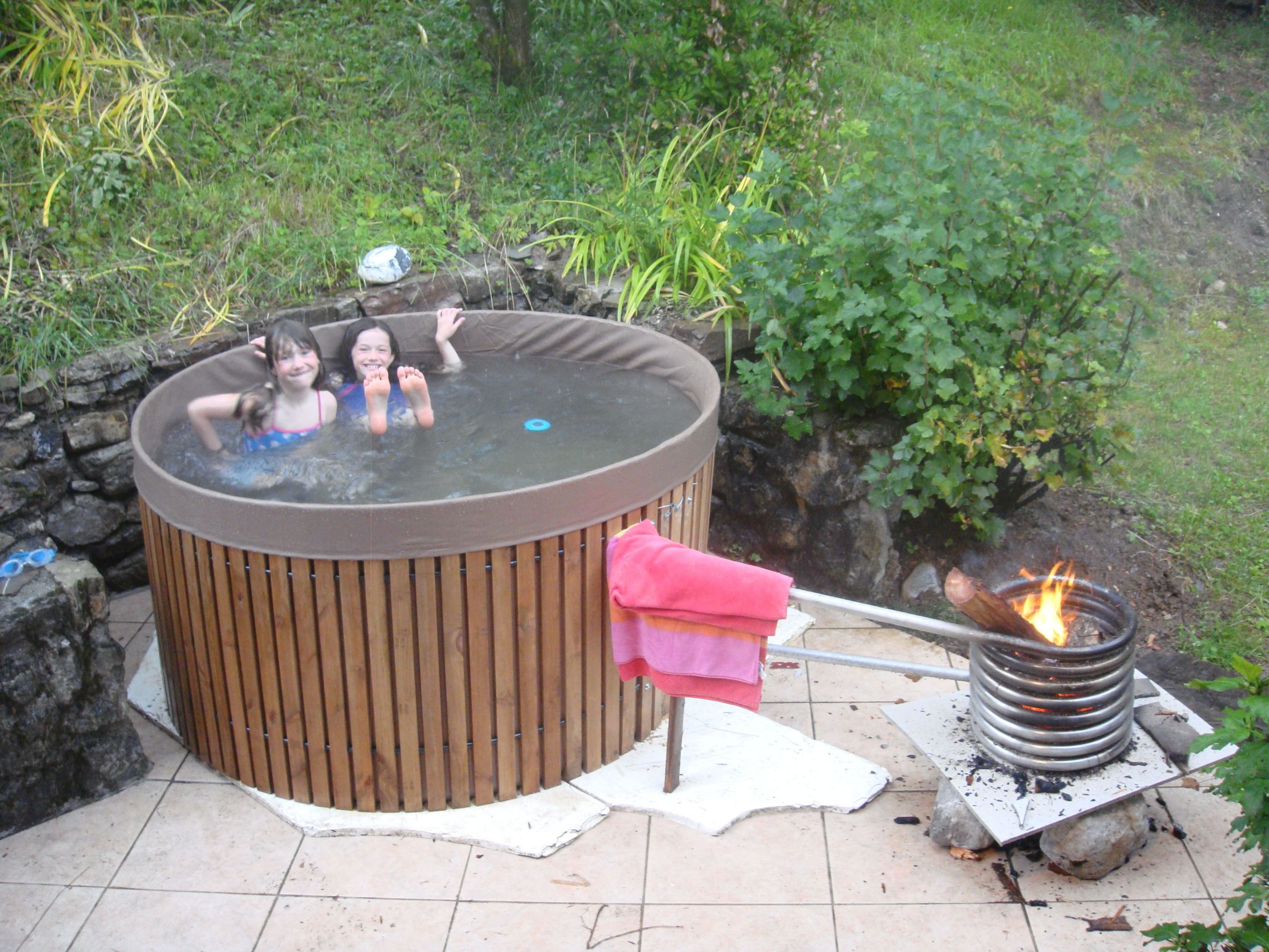 DIY Outdoor Hot Tub
 wood fire inside pipe spiral Hot water rises and draws in