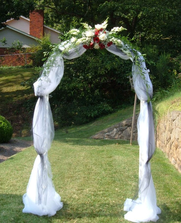 How To Decorate A Wedding Arch
 Wedding arch covered with tulle and accented with flowers
