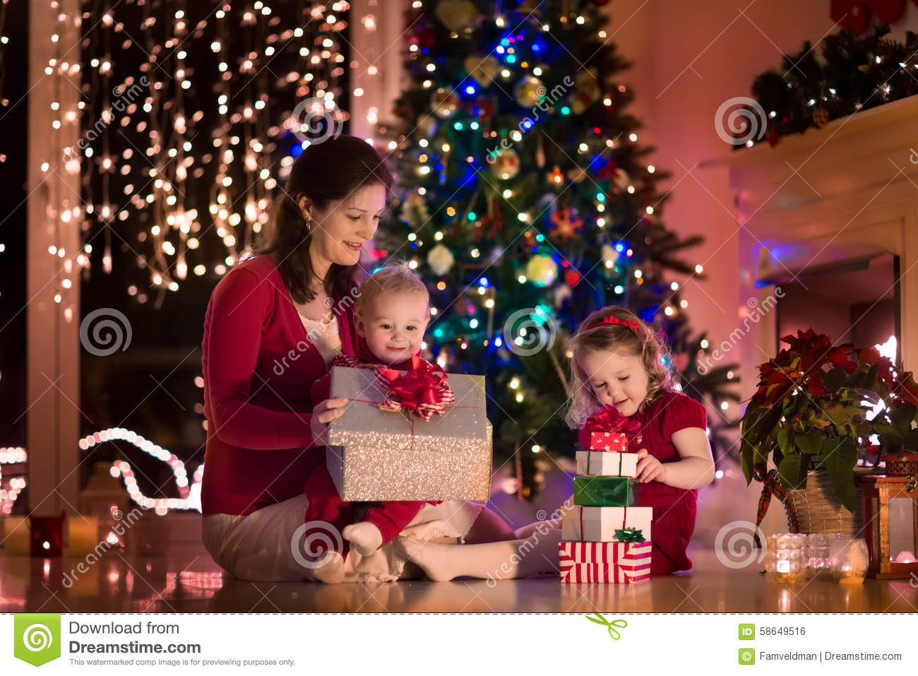 How To Gift A House To A Child
 Mother And Children At Home Christmas Eve Stock