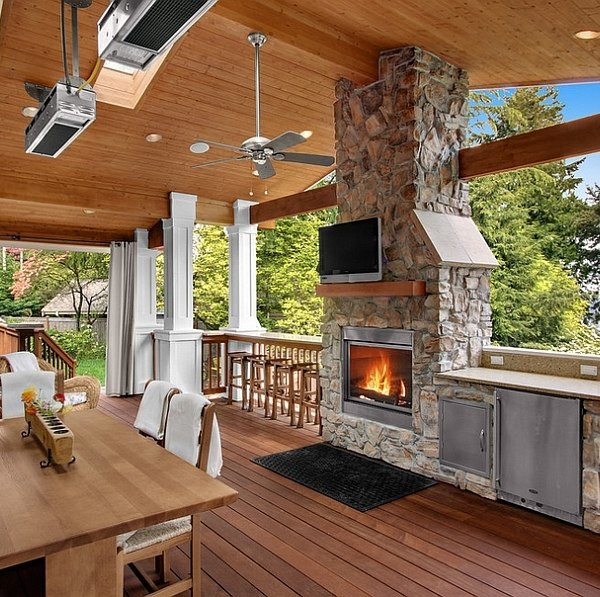 Outdoor Kitchen With Fireplace
 Stone fireplace next to the outdoor kitchen and a lovely