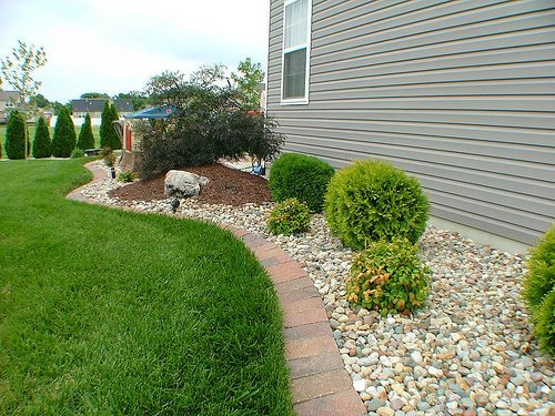 Outdoor Landscape Around House
 landscaping along the side of a house with riverrock