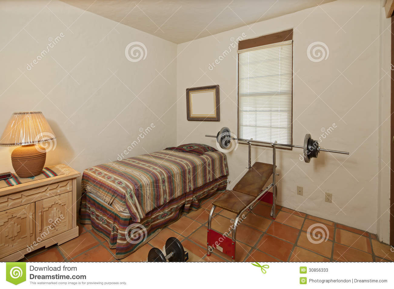 Small Single Bedroom
 Small Single Bedroom With Bench Press And Weights Stock