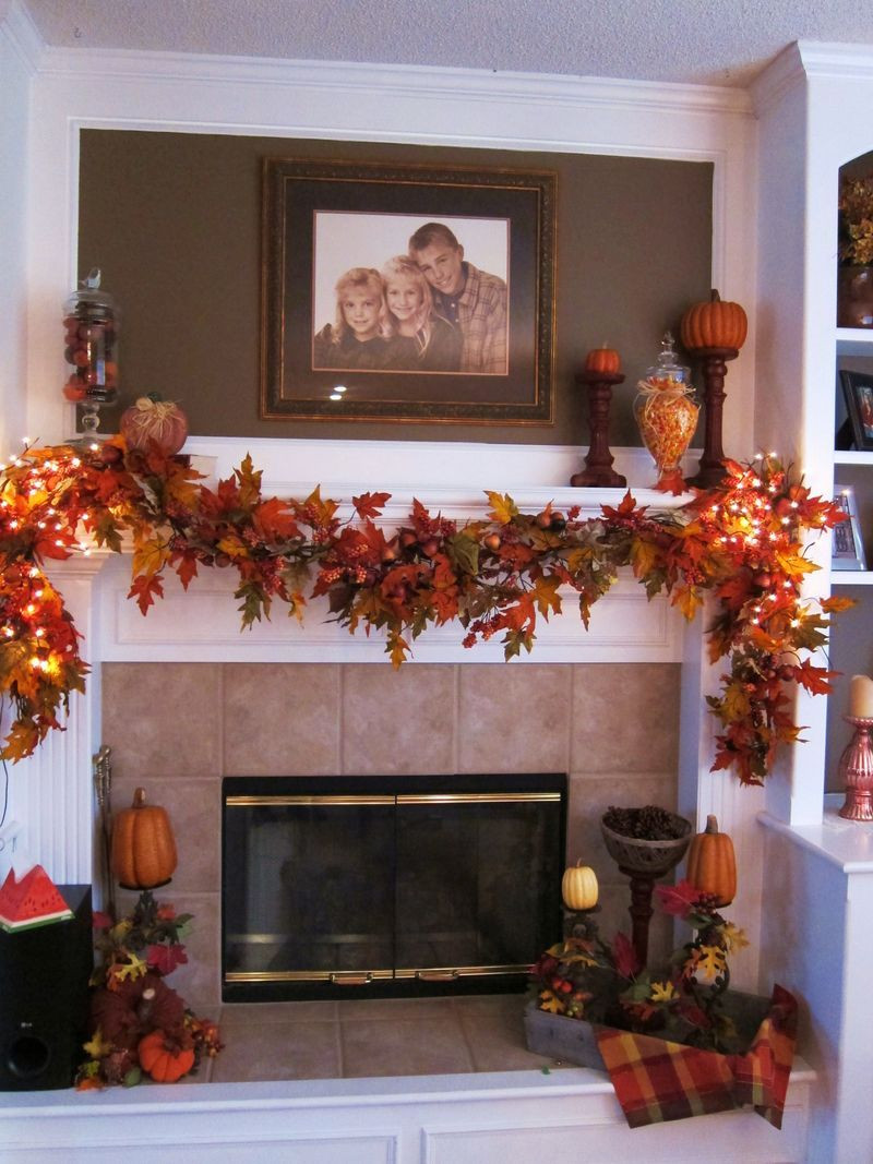 Thanksgiving Fireplace Mantel Decoration
 I like the fall garland and the pumpkins a top wooden