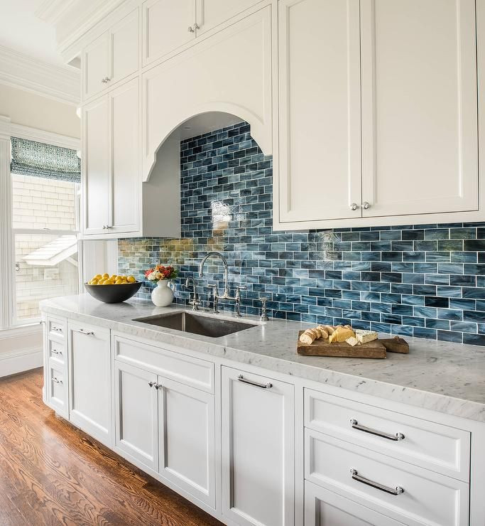 White Kitchen Blue Backsplash
 White and blue kitchen features white shaker cabinets