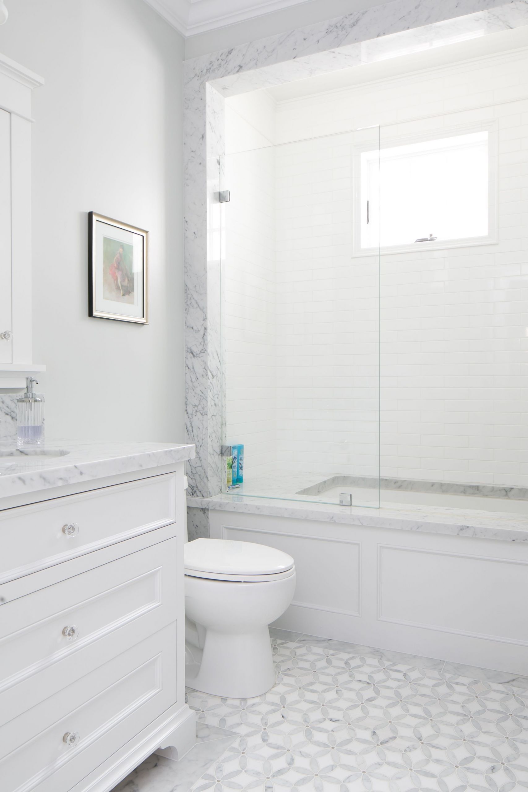 White Tile Bathroom Floor
 This white bathroom features a unique white and gray tile