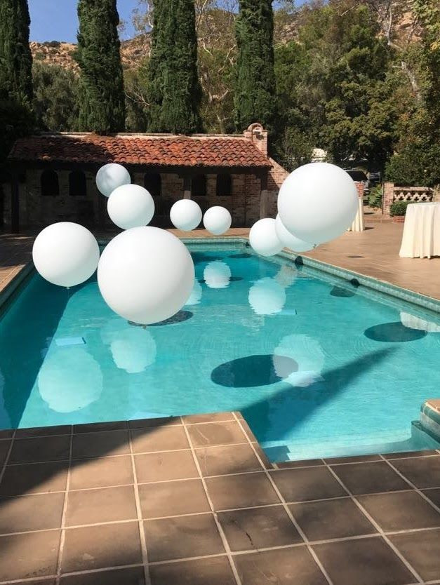 All White Pool Party Ideas
 Jumbo balloons over this pool create a magical look for