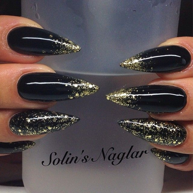 Black Glitter Stiletto Nails
 Black stilettos with gold glitter accents