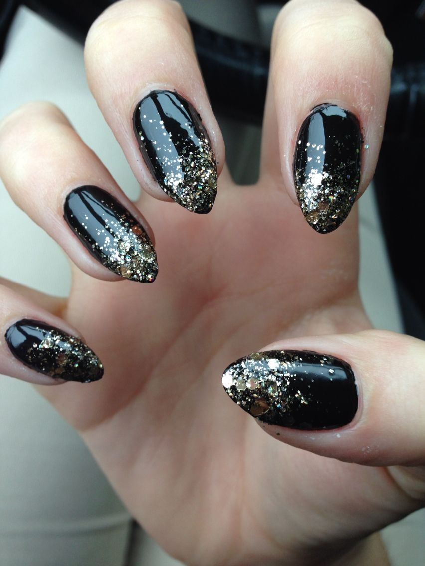 Black Glitter Stiletto Nails
 Stiletto nails black with gold glitter ombré