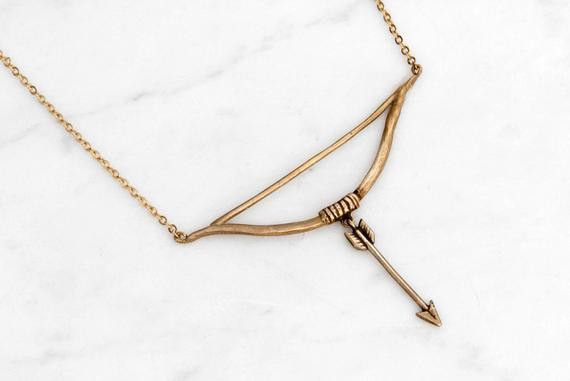 Bow And Arrow Necklace
 Items similar to Golden bow and arrow necklace on Etsy