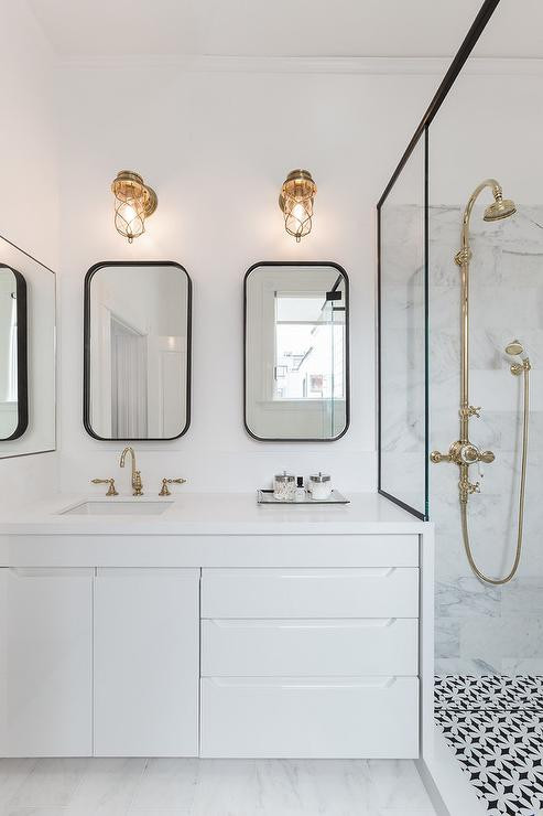 Brass Bathroom Mirror
 Modern Black and White Bathroom with Brass Cage Sconces