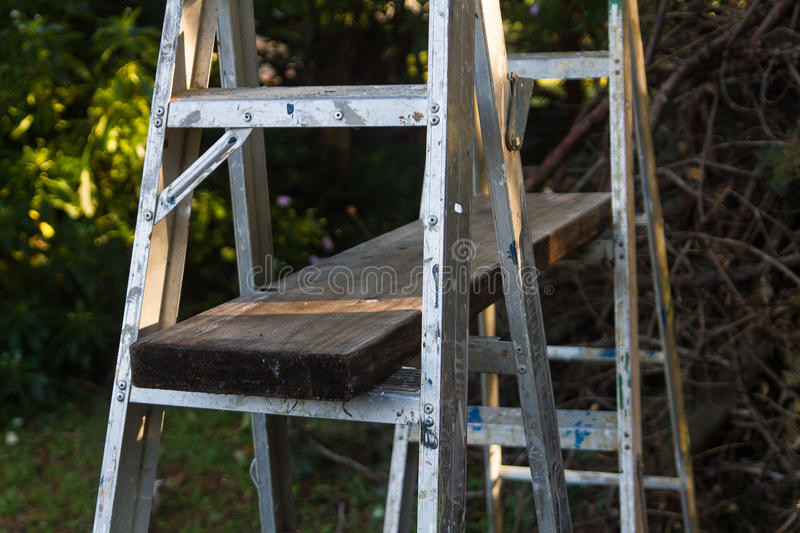 wood plank between ladders for scaffolding