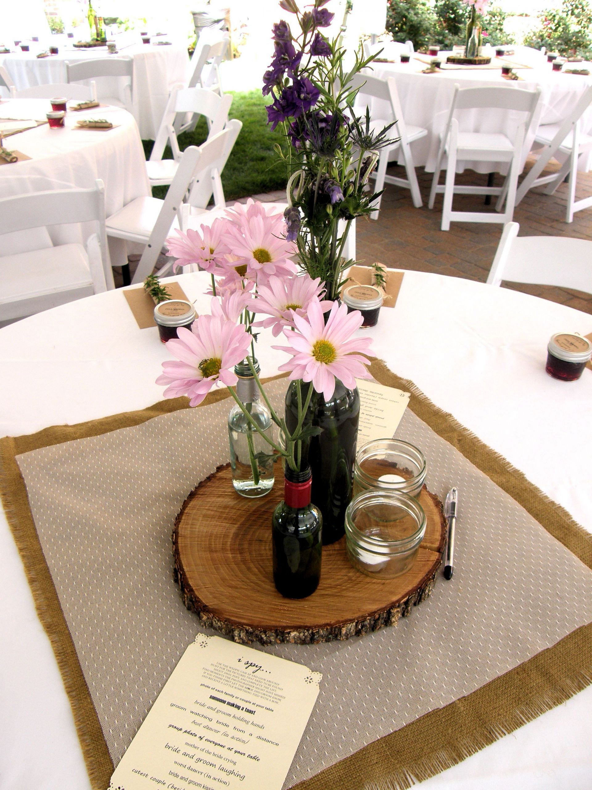 DIY Wood Slab Centerpieces
 Wooden slab centerpieces with old wine bottles labeled