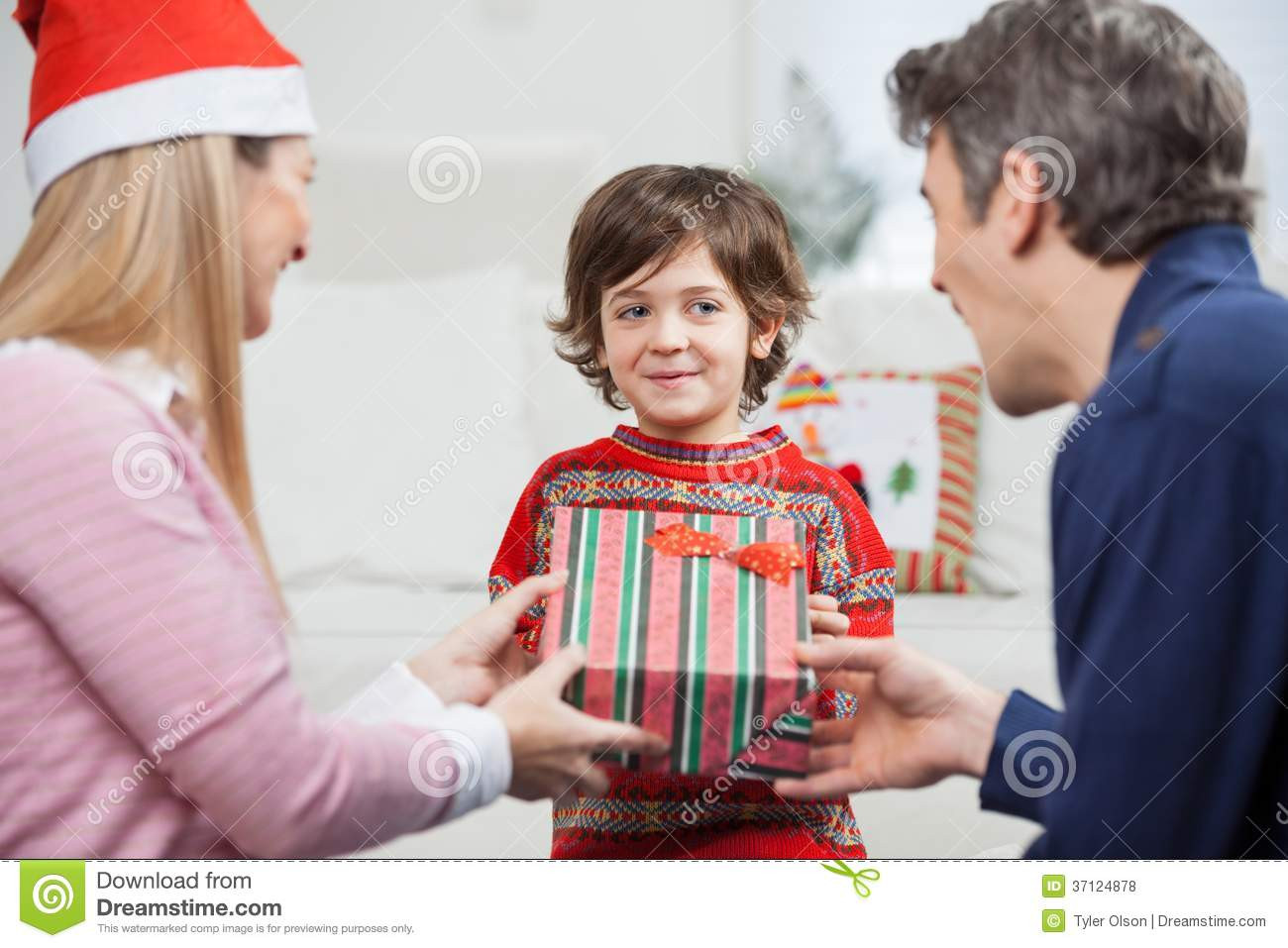 Gift To Children
 Boy Receiving Christmas Gift From Parents Stock