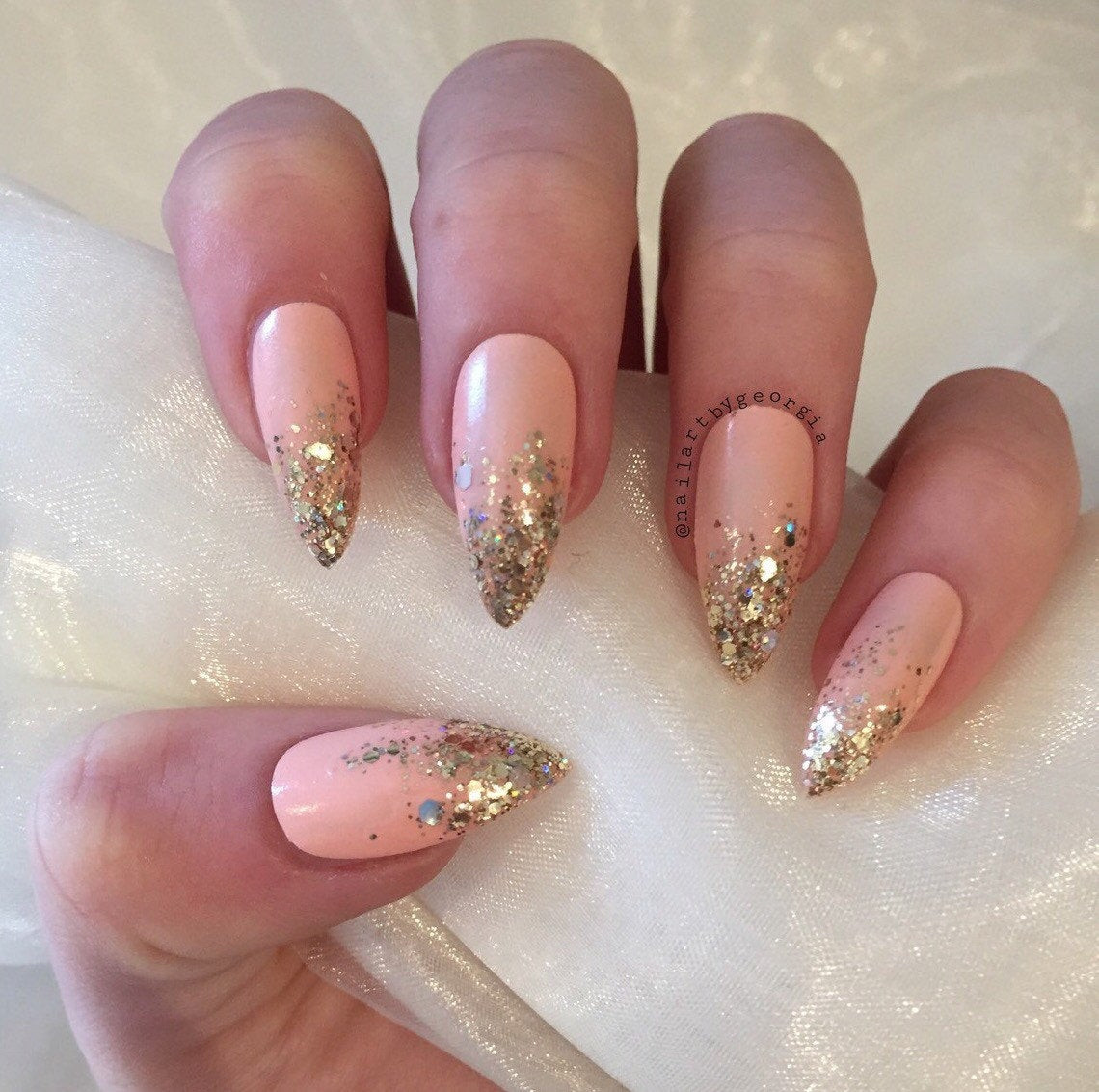 Gold Glitter Ombre Nails
 Peach stiletto false nails with gold glitter ombre