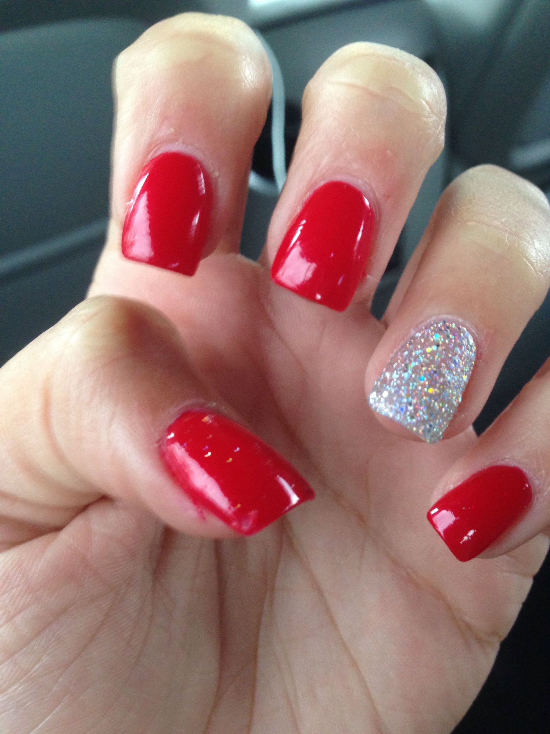 Red Glitter Nails
 Acrylics Red with glitter nail on ring finger