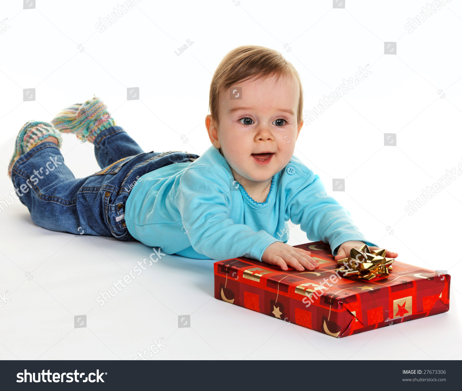 Small Gift For Child
 Small Child With A Baby Gift Package For Christmas Stock