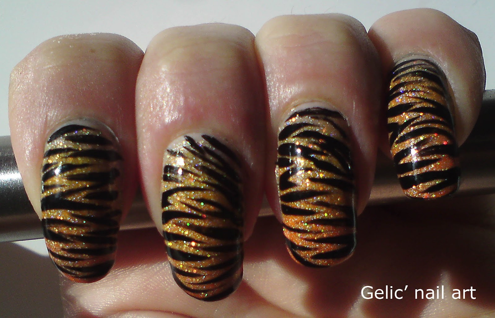 Tiger Nail Art
 Gelic nail art Tiger nail art on orange neon holo gra nt