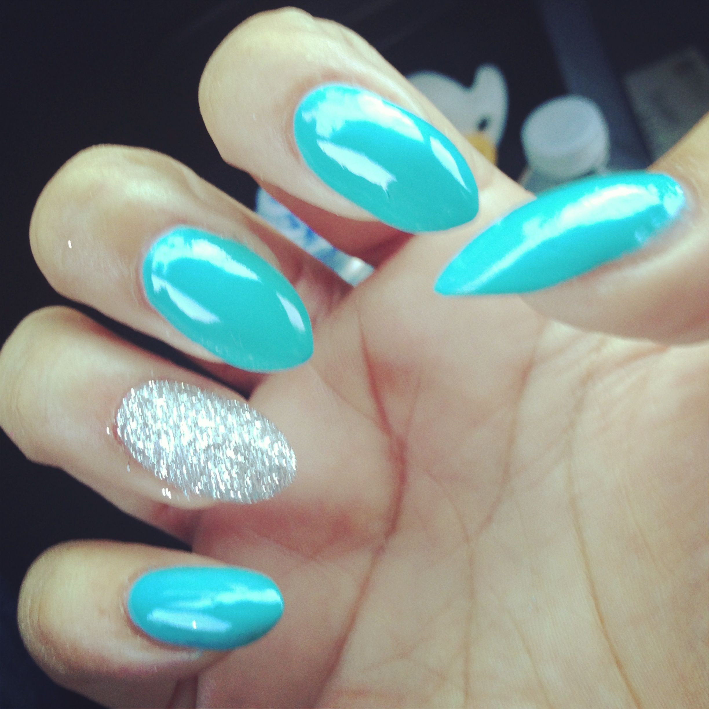 Turquoise Glitter Nails
 Turquoise and accent glitter almond nails